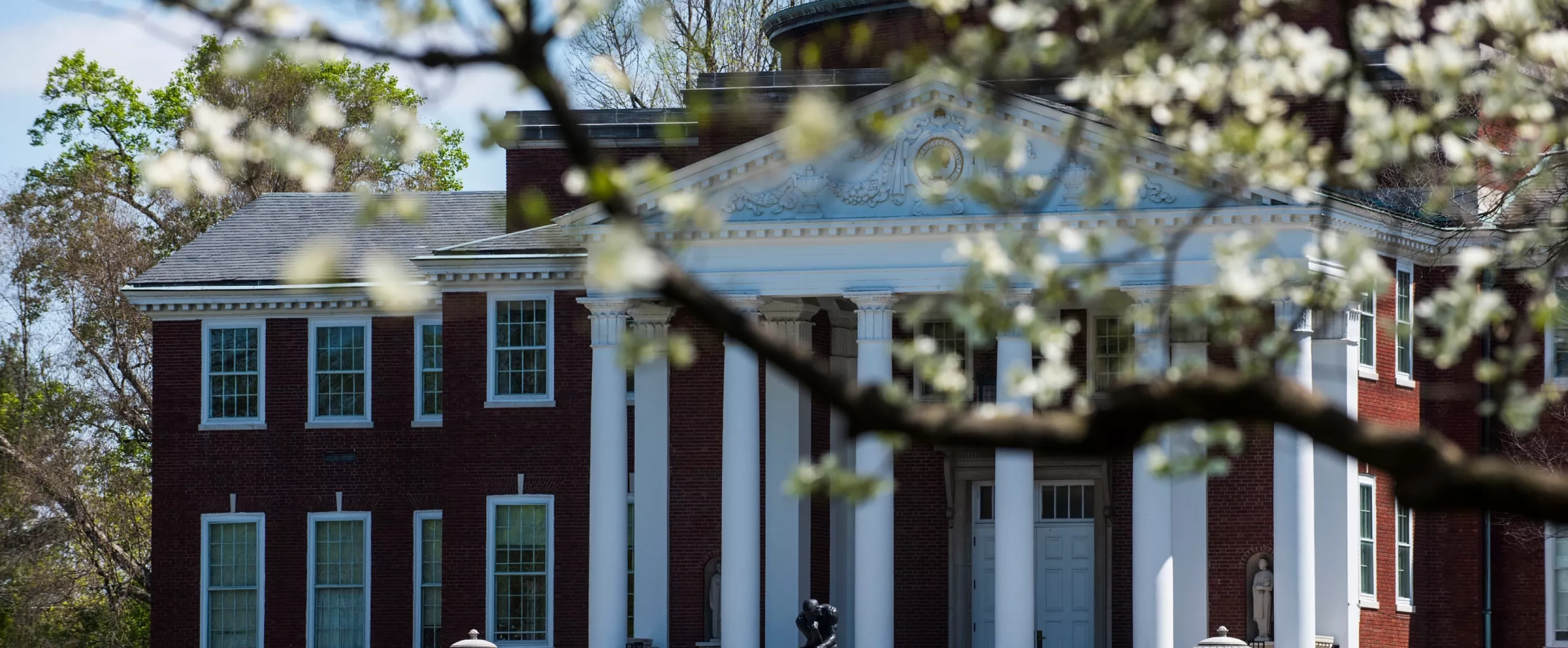 Exterior of Grawemeyer Hall with spring trees in bloom