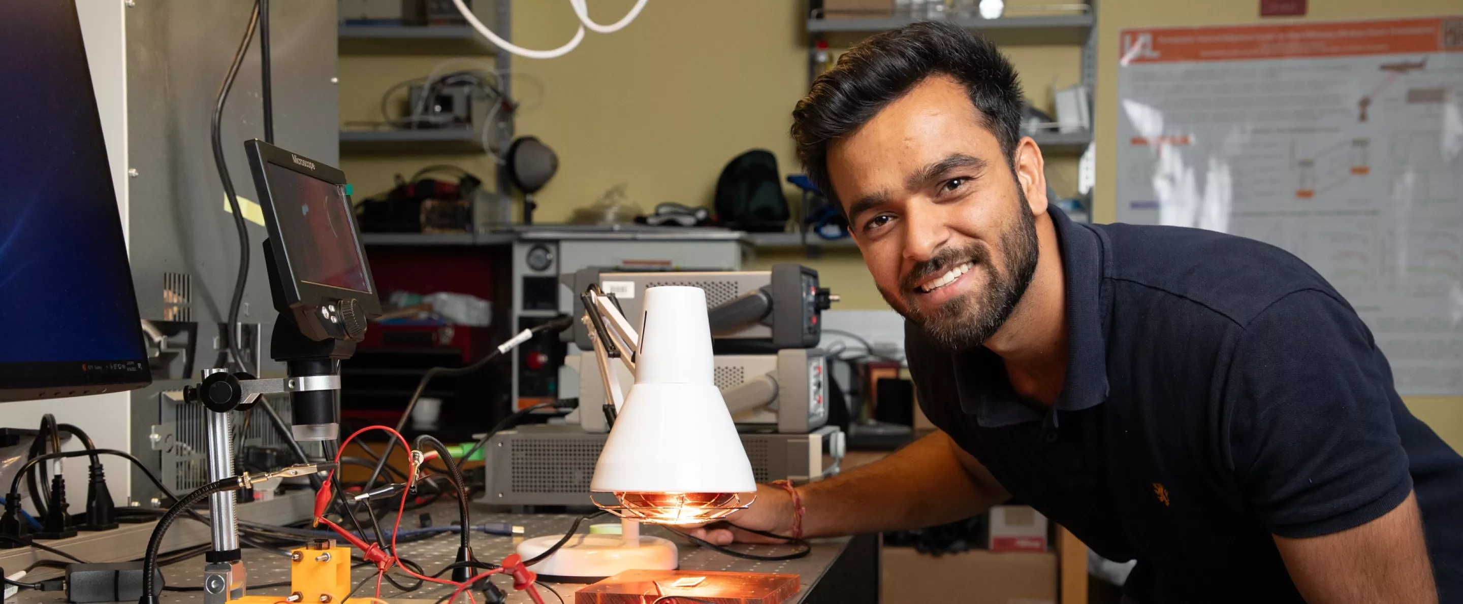 Student looking at the camera in an engineering lab environment