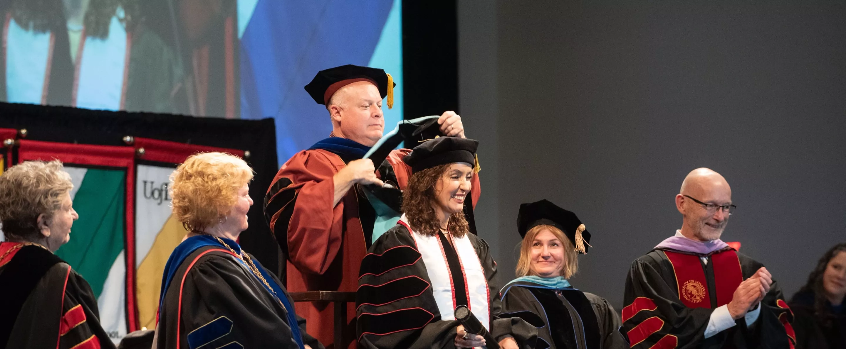 Graduate member hooding student