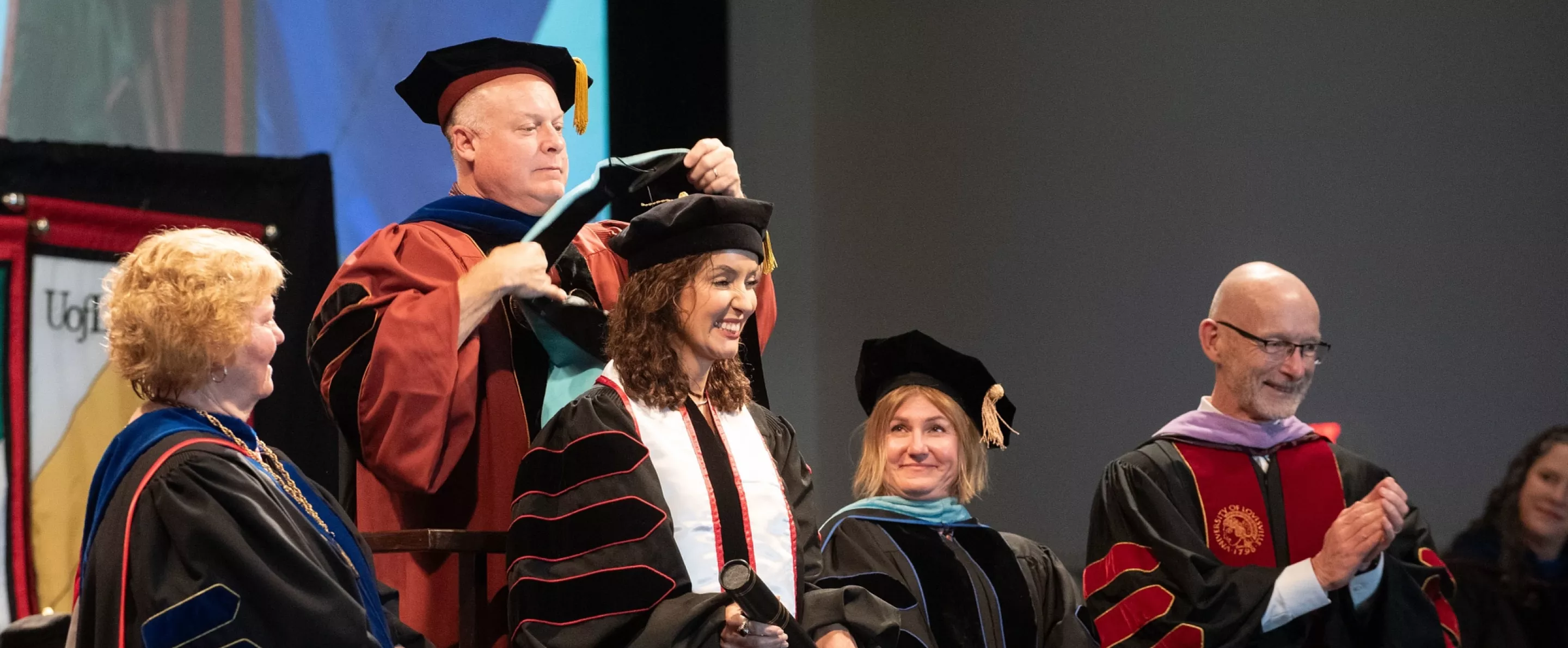 Graduate student getting hooded during the ceremony.