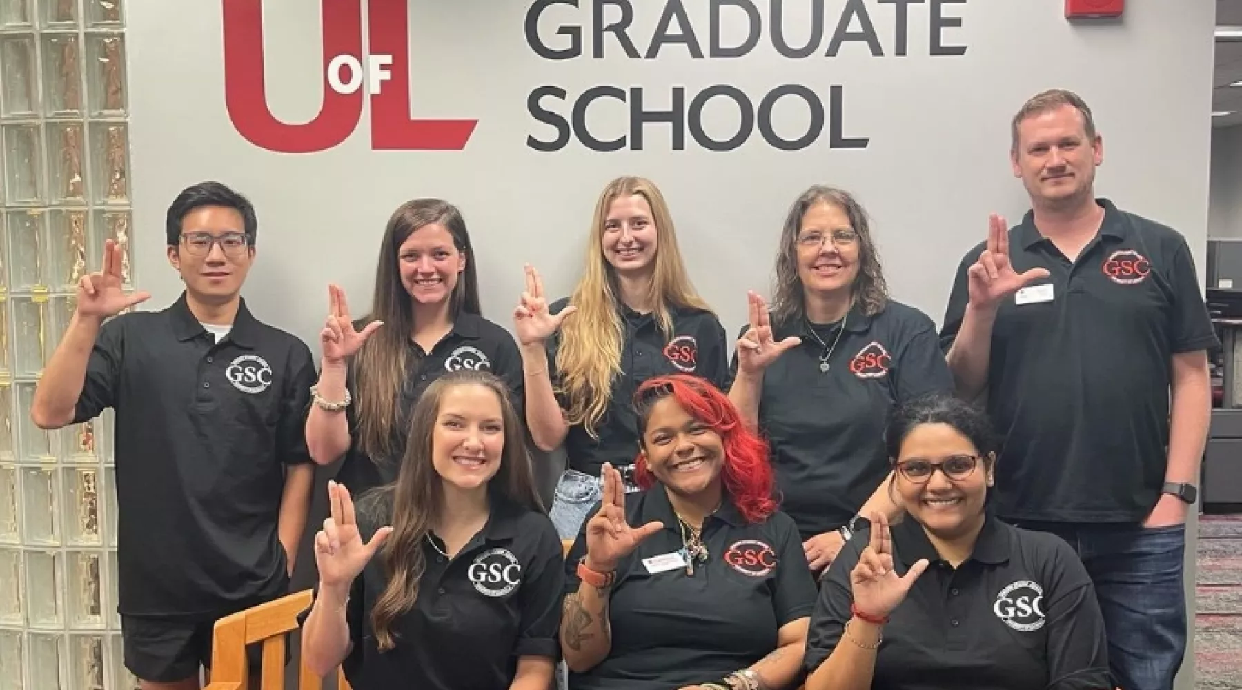 Graduate student council members raising their Ls.