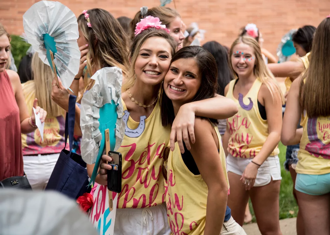 Two sorority members smile for the camera.