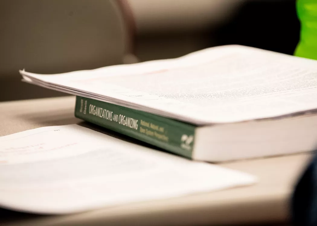 Close up image of a textbook in School of Public Health and Information Sciences.
