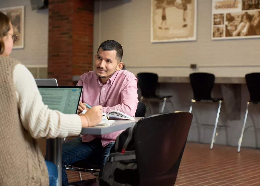 Students talking and studying.