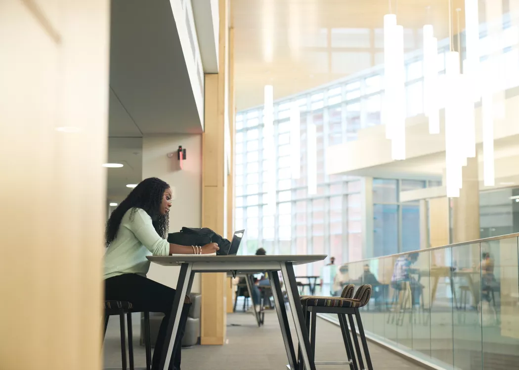 Student studying at a table in the BAB.