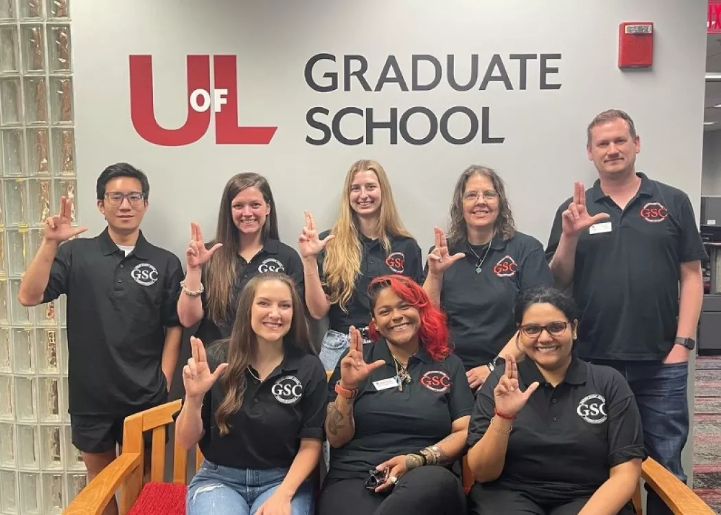 Graduate student council members raising their Ls.