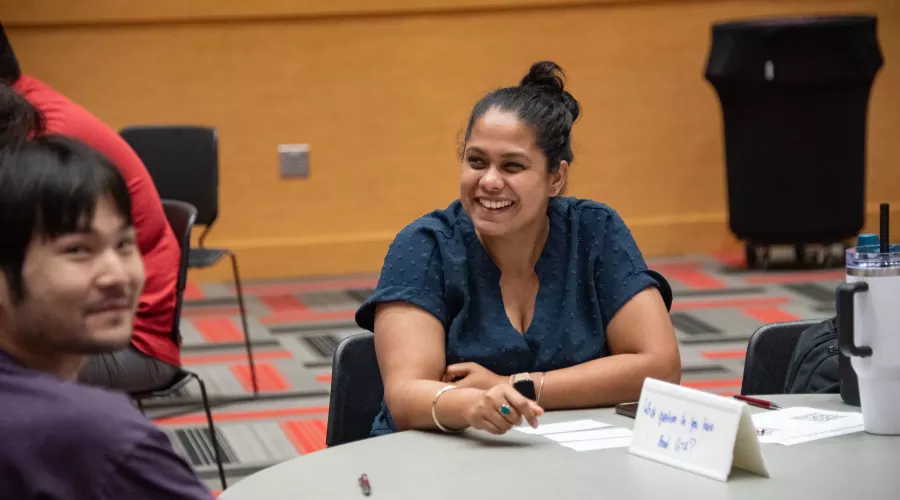 Graduate student smiling during orientation.