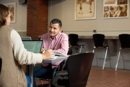 Students talking and studying.